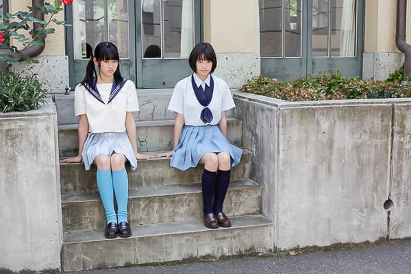 Nylon-covered foot with visible arch and delicate toe separation, gentle shadows and soft focus